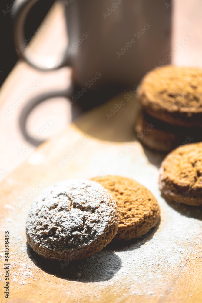 oatmeal cookies on a wooden board sprinkled with powdered sugar, toned oatmeal cookies on a wooden board sprinkled with powdered sugar, toned