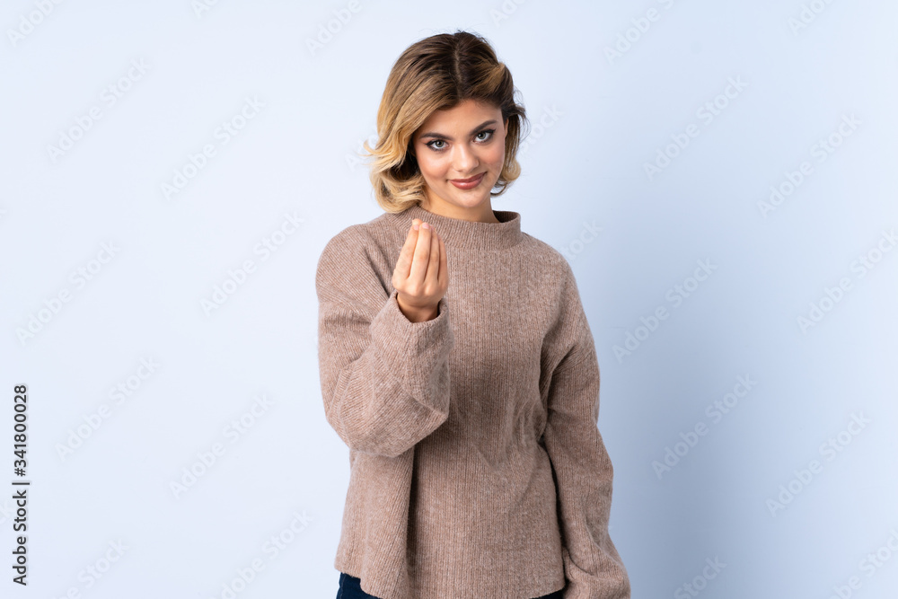 Young Russian woman isolated on blue background making money gesture Young Russian woman isolated on blue background making money gesture
