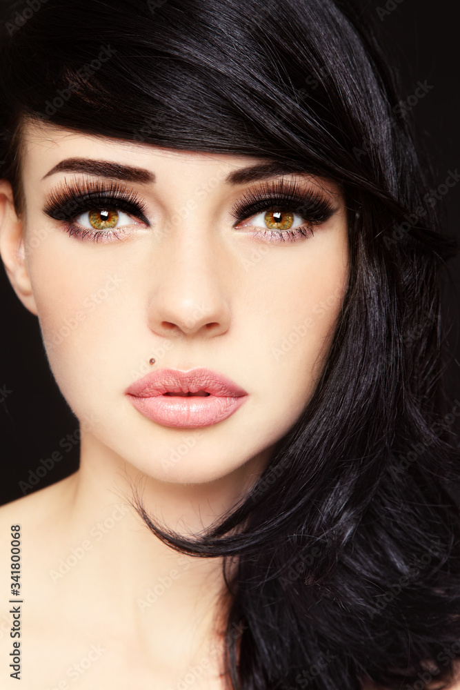 Close-up portrait of young beautiful woman with fansy makeup and false eyelashes Close-up portrait of young beautiful woman with fansy makeup and false eyelashes