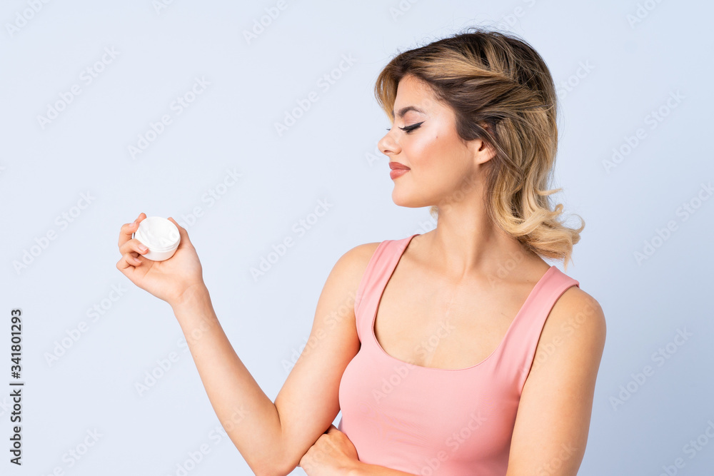 Young girl with moisturizer with happy expression Young girl with moisturizer with happy expression