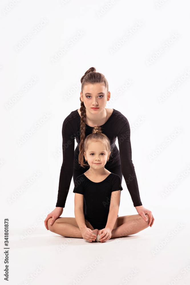 Rhythmic gymnastics. Girl gymnast and trainer perform various gymnastic