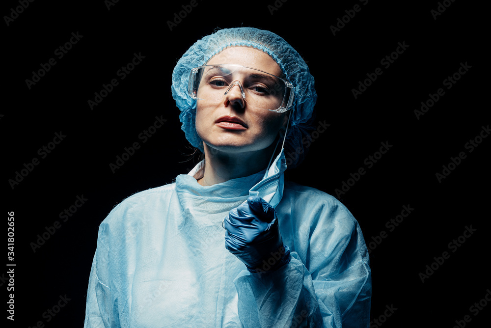 tired medical worker doctor nurse rips off a medical mask she is tired of quarantine, a huge flow of patients