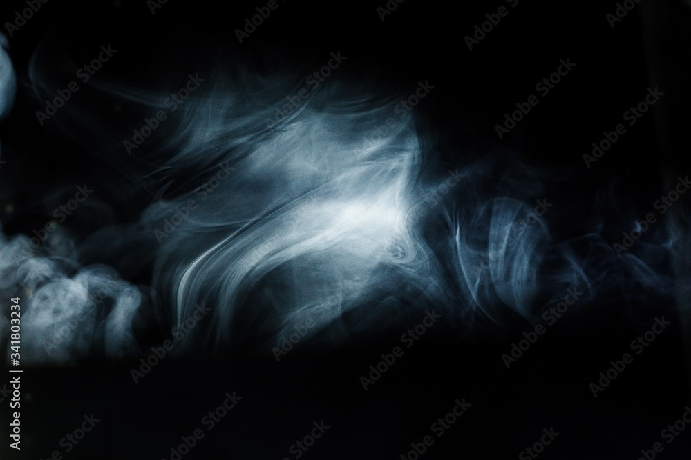 Obraz premium Ray of light with smoke and fog spotlights on the stage. Scene light equipment
