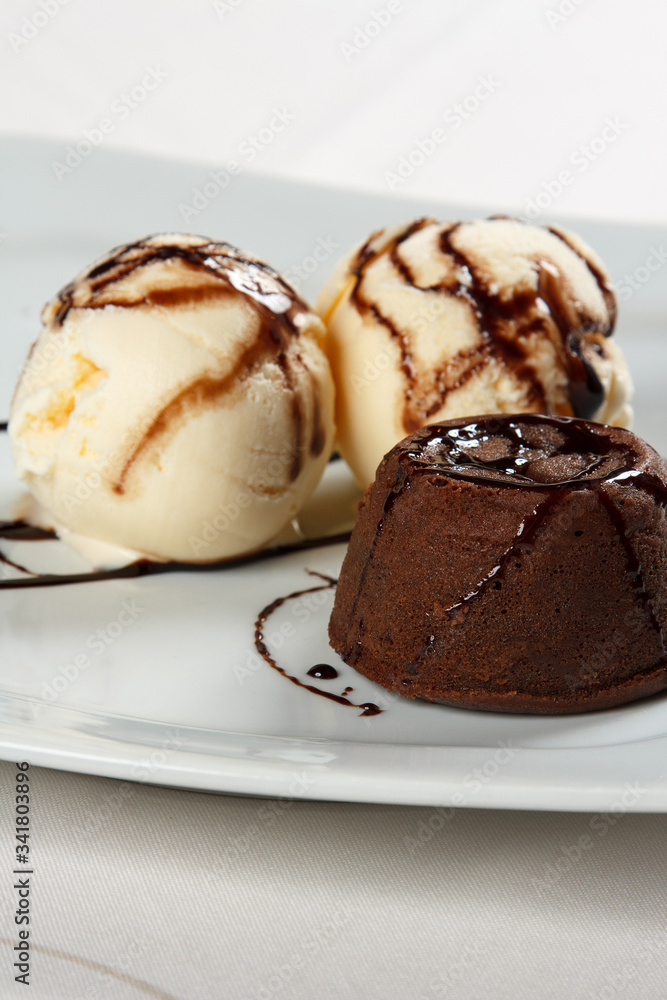 petit gateau with ice cream and chocolate sauce. petit gateau with ice cream and chocolate sauce.
