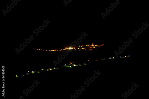 Town of Artenara to the background and village of El Toscon to the foreground at night. Gran Canaria. Canary Islands. Spain. photo