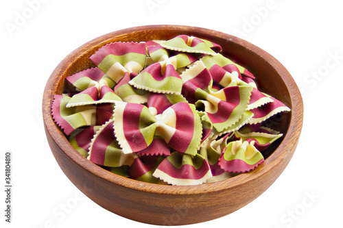 colored farfalle pasta in a plate on  white background