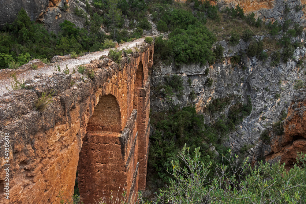 Ancient roman aqueduct made from stone and clay in Spain