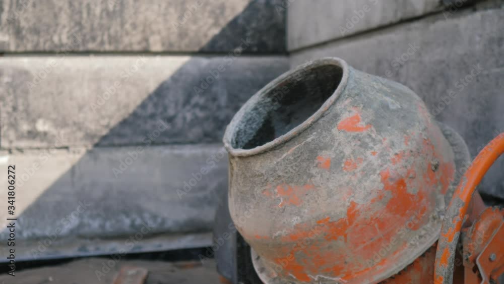 Industrial cement mixer machine a construction site. concept building constructing architect concrete pouring lifestyle. Mixes the sand, gravel and water Industrial cement mixer machine a construction site. concept building constructing architect concrete pouring lifestyle. Mixes the sand, gravel and water