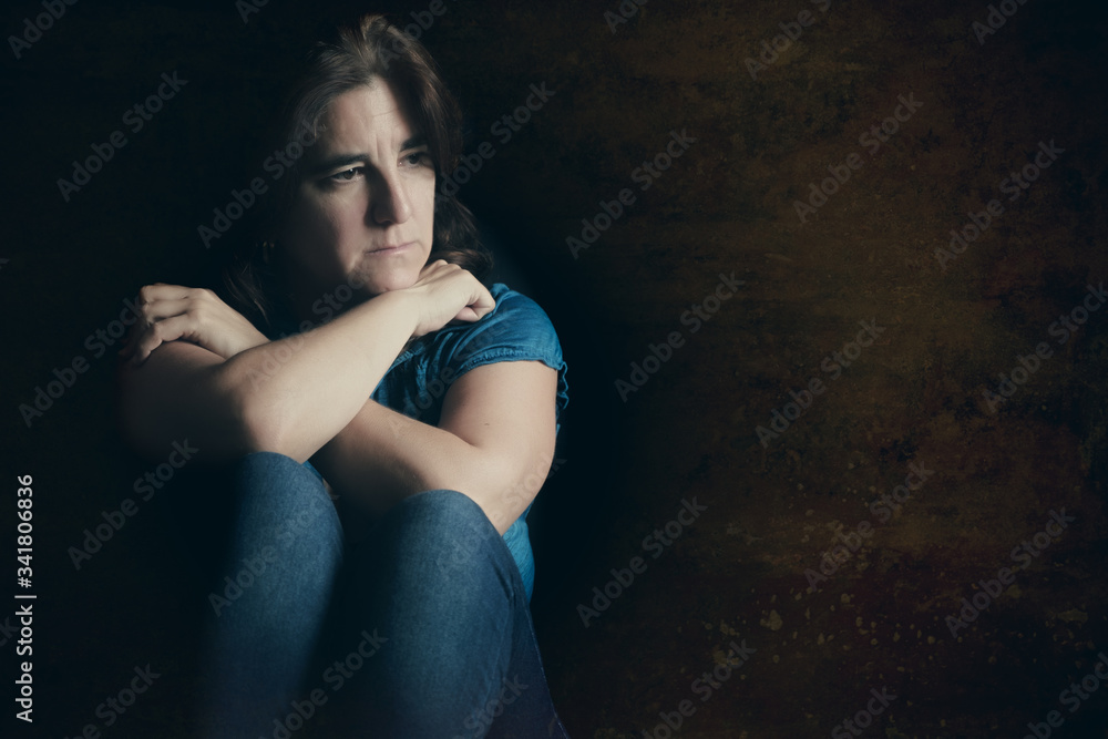 Sad and lonely woman with a grunge background Sad and lonely woman with a grunge background