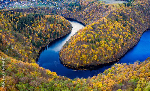 Beautiful Vyhlidka Maj, Lookout Maj, near Teletin, Czech Republic. Meander of the river Vltava surrounded by colorful autumn forest viewed from above. Tourist attraction in Czech landscape. Czechia. photo