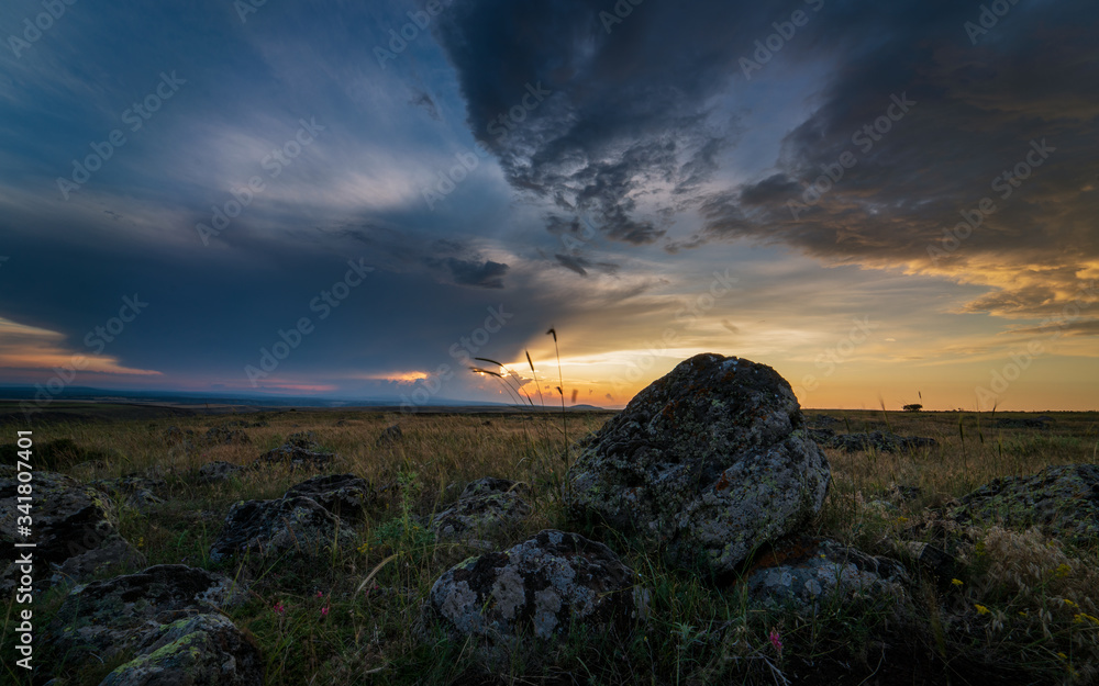 Sunset over the steppe landscape and wonderful clouds