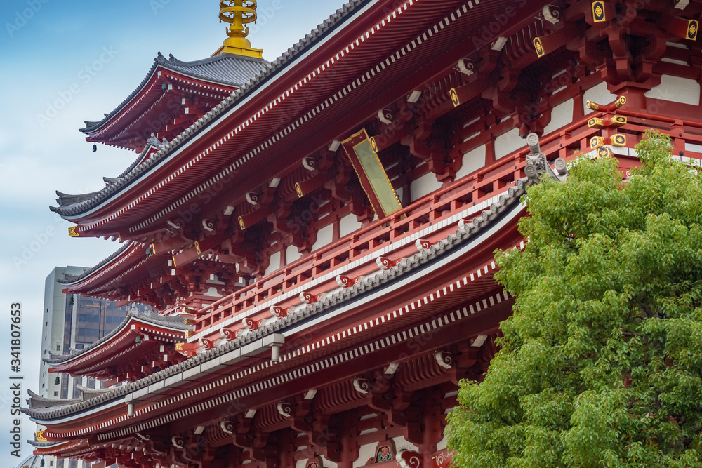 Japan. Asakusa in Tokyo. Buddhist pagoda near the temple. Tokyo in sunny weather. Sensoji Temple on a summer day. Buddhist temples on the background of a modern building. Japan tour. Japan. Asakusa in Tokyo. Buddhist pagoda near the temple. Tokyo in sunny weather. Sensoji Temple on a summer day. Buddhist temples on the background of a modern building. Japan tour.