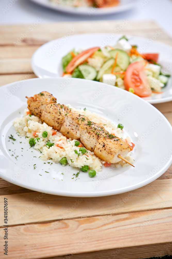 chicken kebab with rice and salad on the wooden background chicken kebab with rice and salad on the wooden background