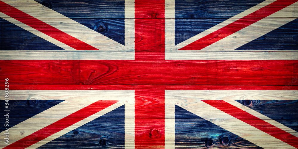 Fototapeta premium An old Union Jack on wooden surface