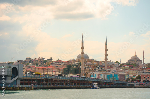 Tourist pleasure boats on pier in Golden Horn Bay. View of famous Hagia (Aya) Sofia Museum and the New Mosque. Popular tourist destination. Turkey, Istanbul, Bosphorus
