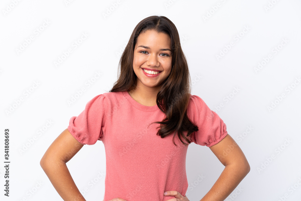 Young Colombian girl over isolated white background posing with arms at hip and smiling Young Colombian girl over isolated white background posing with arms at hip and smiling