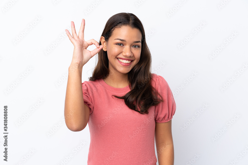 Young Colombian girl over isolated white background showing ok sign with fingers