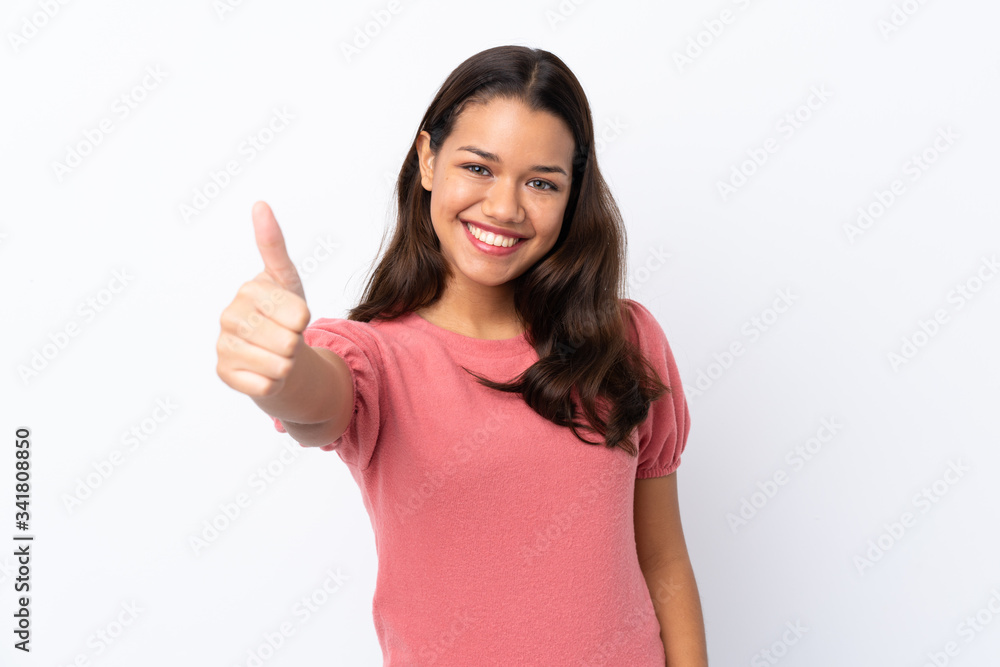 Young Colombian girl over isolated white background with thumbs up because something good has happened Young Colombian girl over isolated white background with thumbs up because something good has happened