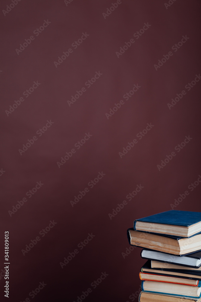 a lot of stacks of educational books in the college library on a brown background a lot of stacks of educational books in the college library on a brown background