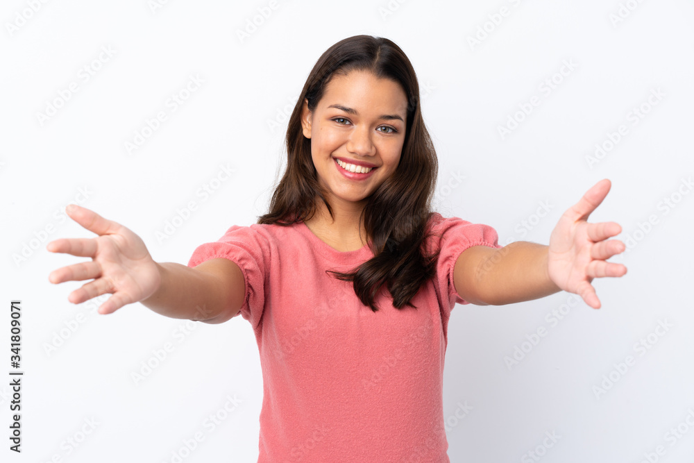 Young Colombian girl over isolated white background presenting and inviting to come with hand Young Colombian girl over isolated white background presenting and inviting to come with hand
