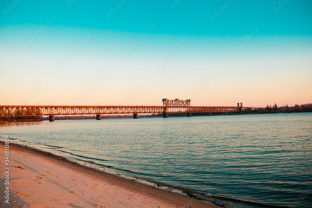 Long bridge over the river and the beach
