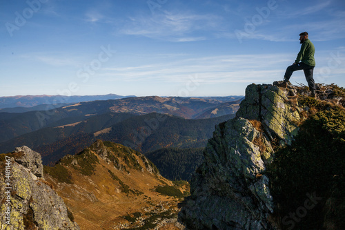 Man standing on the cliff in mountains