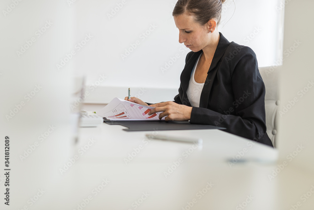 Businesswoman working on financial report Businesswoman working on financial report