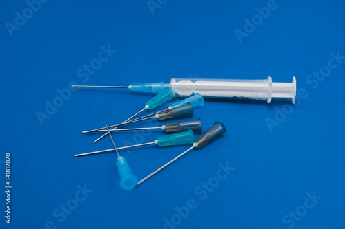 medical syringes on blue background