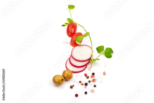 Sliced radish with cherry tomatoes and olives, isolated on white background