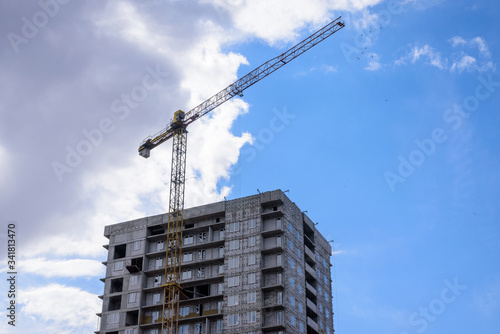 Crane on the construction of a residential building. © delobol