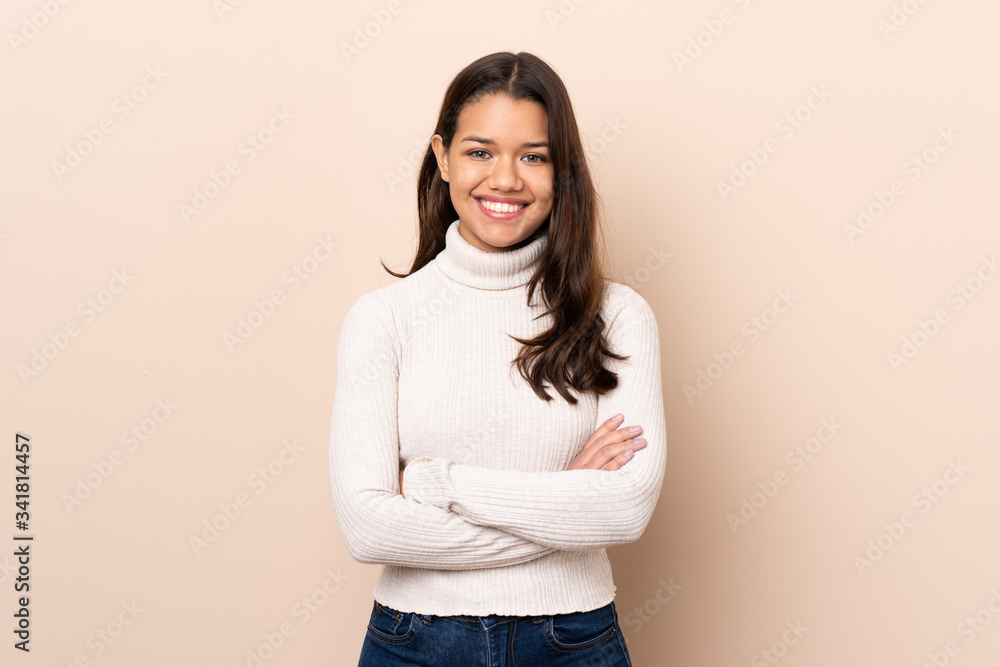 Young Colombian girl over isolated background keeping the arms crossed in frontal position Young Colombian girl over isolated background keeping the arms crossed in frontal position