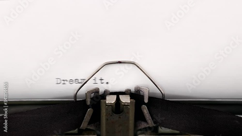Typing a motivational quote dream it wish it do it on a vintage typewriter