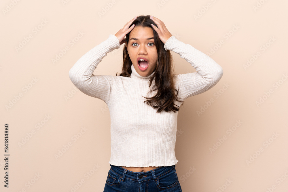 Young Colombian girl over isolated background with surprise expression Young Colombian girl over isolated background with surprise expression