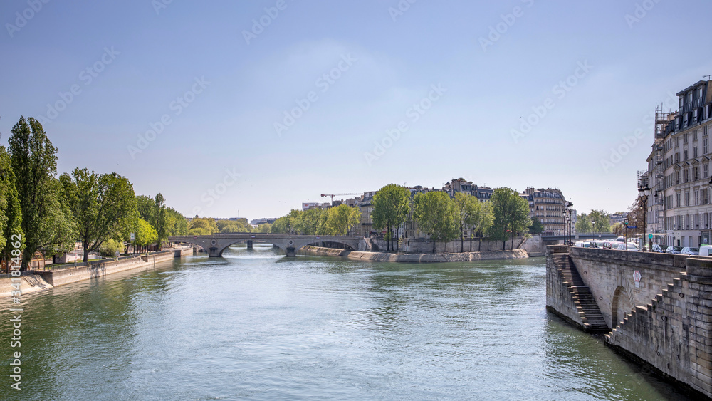 Paris, France - April 16, 2020: Seine river during lockdown. There is no one on the banks, on the bridge and on the Seine because of containment measures