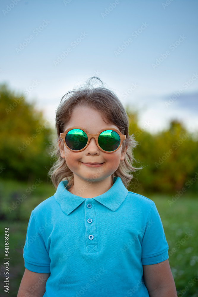 Happy oy in sunglasses at summer outdoors Happy oy in sunglasses at summer outdoors