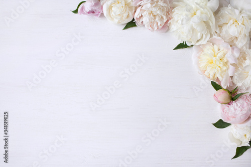 Fototapeta Naklejka Na Ścianę i Meble -  Light pink and white peonies on a white wooden background
