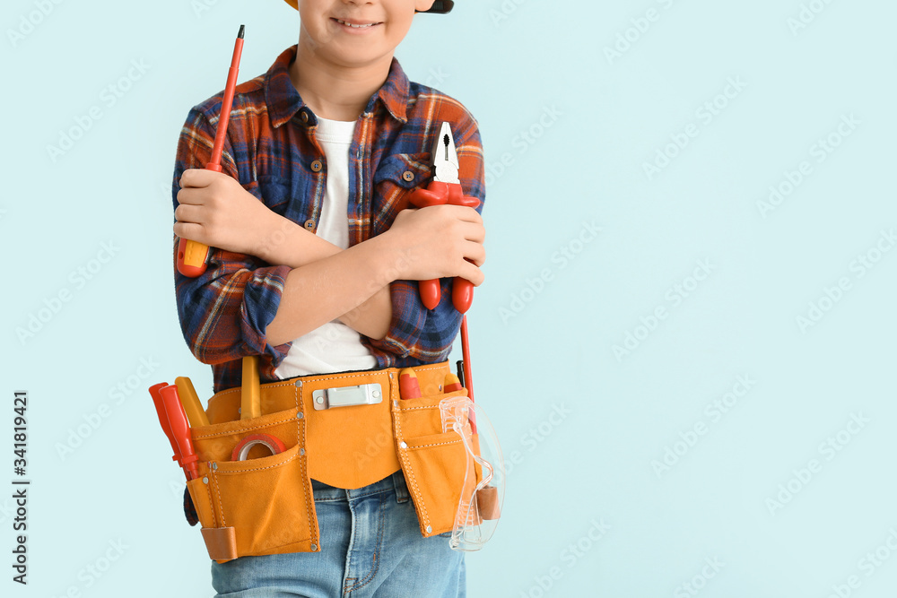 Cute little electrician on color background Cute little electrician on color background