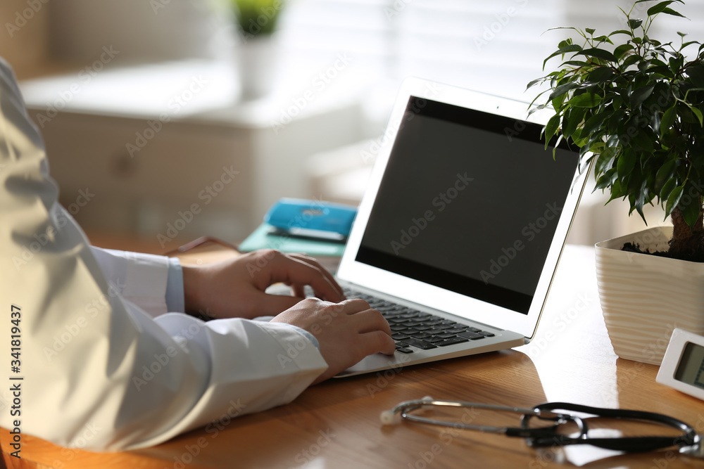 Professional doctor working on laptop in office, closeup Professional doctor working on laptop in office, closeup
