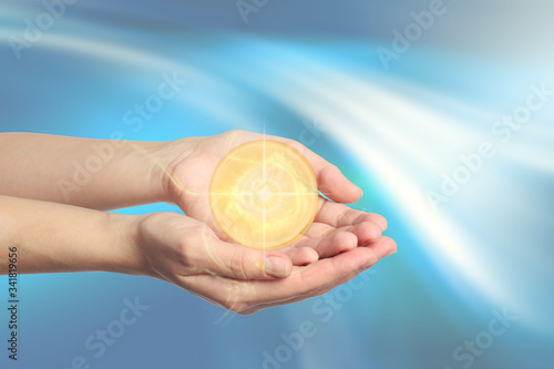 Woman holding concentrated healing energy in her hands  closeup