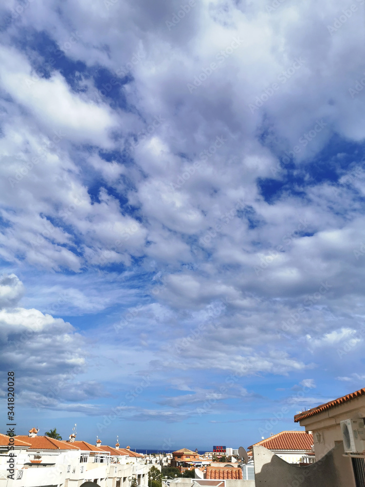 panorama of the town against a huge blue sky with cumulus clouds