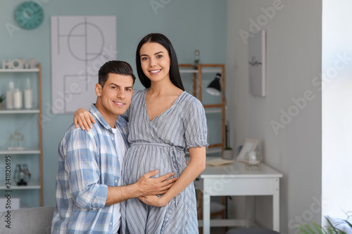 Portrait of happy pregnant couple at home © Pixel-Shot