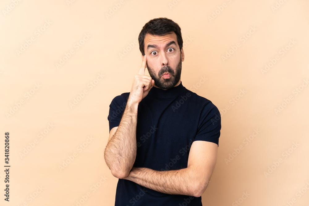 Caucasian handsome man over isolated background thinking an idea Caucasian handsome man over isolated background thinking an idea