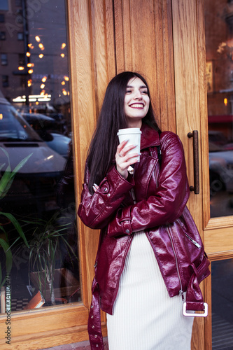 young pretty girl outside in city street with coffee happy smiling, lifestyle fashion peopple concept