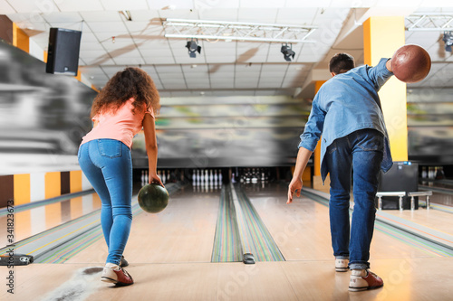 Friends playing bowling in ...