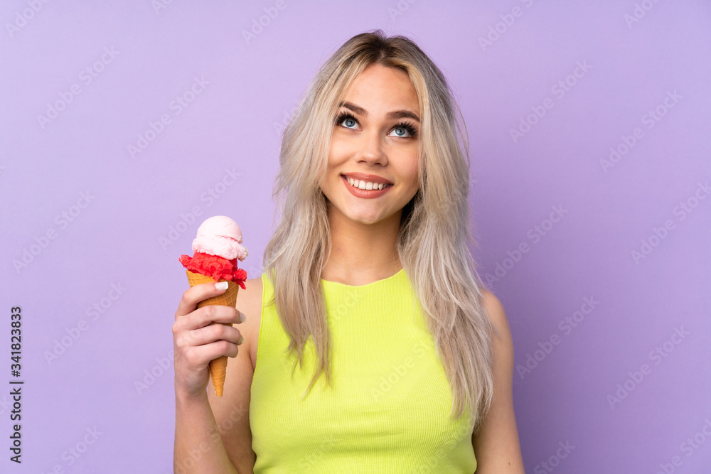 Teenager girl over isolated purple background looking up while smiling Teenager girl over isolated purple background looking up while smiling