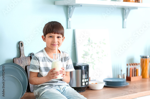 Little boy with milk in kit...