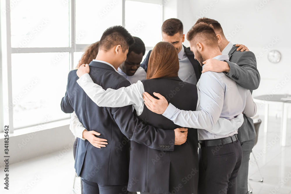 Group of business people hugging in office. Unity concept Group of business people hugging in office. Unity concept