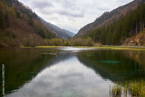 Fototapeta Naklejka Na Ścianę i Meble -  mountain lake with cloud reflection in the mountains of the alps