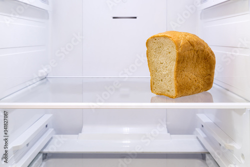 half a loaf of bread on the shelf in the empty refrigerator