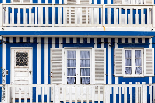 Street with colorful houses in Costa Nova, Aveiro, Portugal. Street with striped houses, Costa Nova, Aveiro, Portugal. Facades of colorful houses in Costa Nova, Aveiro, Portugal.